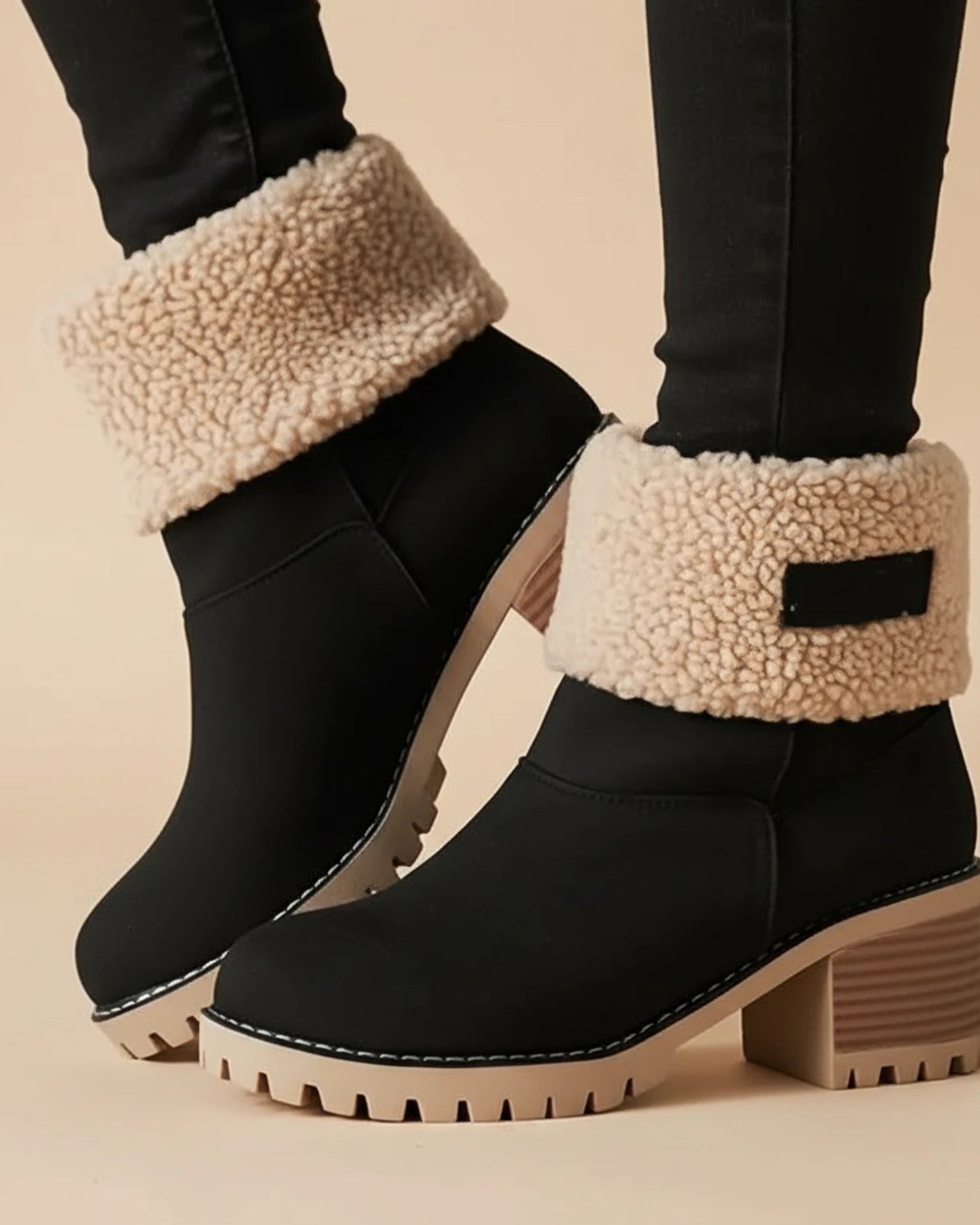 Orthopedic sherpa-cuff ankle boots in black.