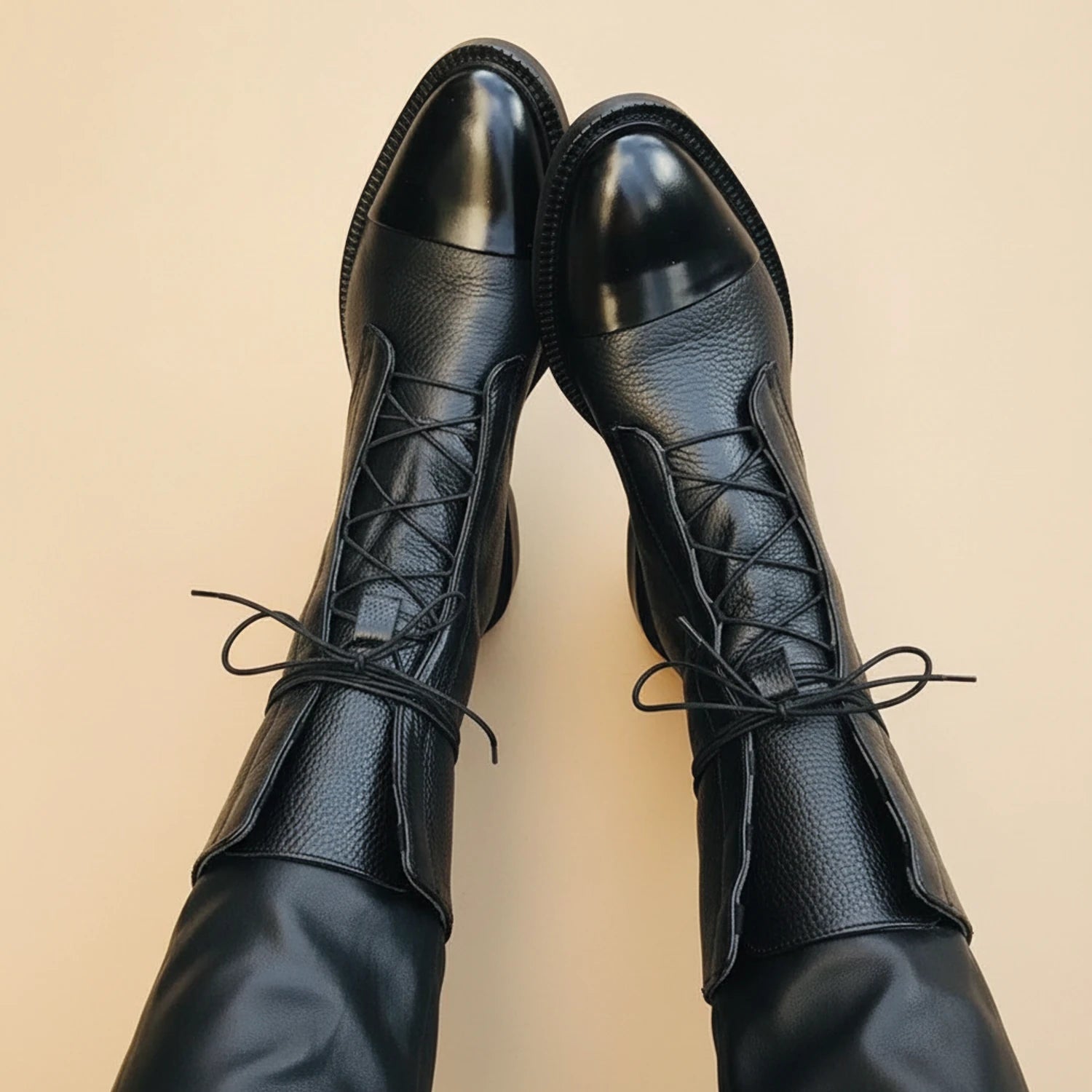 Lace-up combat ankle boots in black.